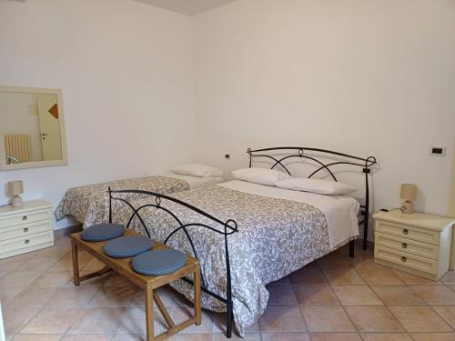 a bedroom with two beds and two tables and a mirror at A 2 passi dal blu in Roseto degli Abruzzi