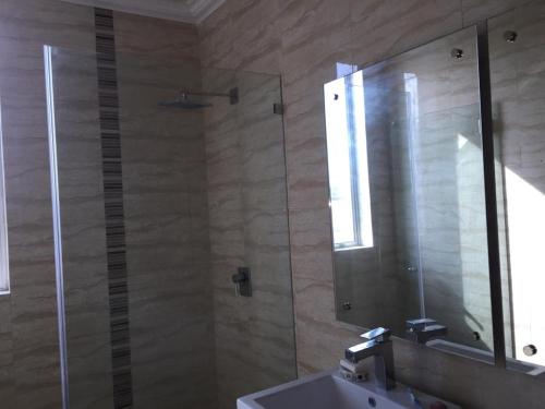uma casa de banho com um chuveiro, um lavatório e um espelho. em MM VILLAGE em Río Hato