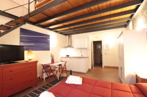 a living room with a couch and a kitchen at Amenano Apartments in Catania