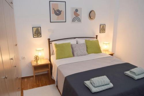 a bedroom with a large bed with two lamps at Lovely,central, spacious 2-bedrooms apartment in Piraeus