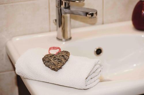 a bathroom sink with a heart sitting on a towel at Lovely,central, spacious 2-bedrooms apartment in Piraeus