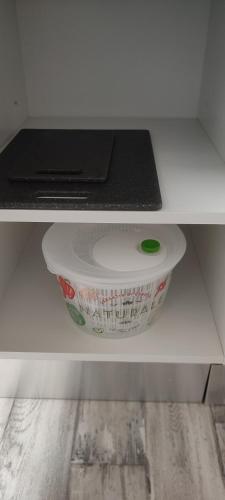 a white bowl on a shelf in a drawer at F2, entièrement neuf, 65m² in Montceau-les-Mines