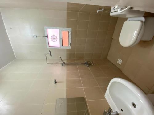 a bathroom with a sink and a toilet in a room at النزل الجميلة in Dammam