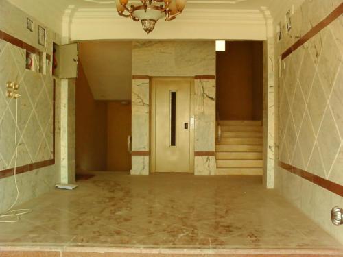 a hallway in a building with a chandelier at النزل الجميلة in Dammam