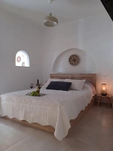 a bedroom with a large bed with a bottle of wine at Nama Seaview Kokkari in Kokkari