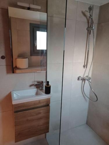 a bathroom with a shower and a sink at Nama Seaview Kokkari in Kokkari