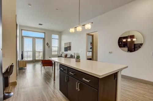 a kitchen with a large island in the middle of a room at Modern 2BR CozySuites on Town Lake waterfront 12 in Tempe