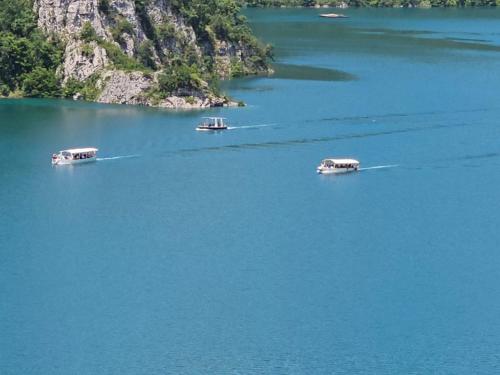 three boats in a large body of water at Guesthouse Madzarevic in Pluzine