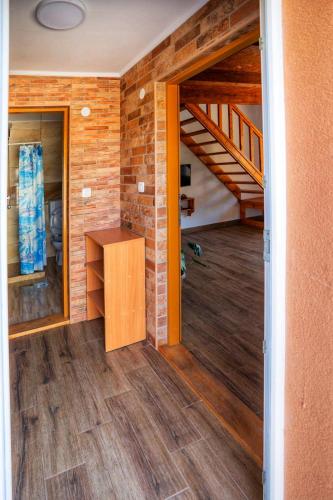 an empty room with a wooden floor and a staircase at Guesthouse Madzarevic in Pluzine