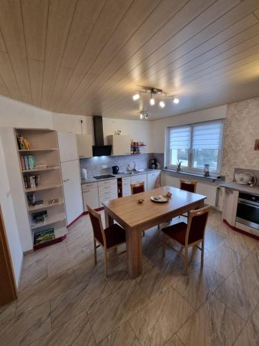 a large kitchen with a wooden table and chairs at Schnuckelige Wohnung in Marl