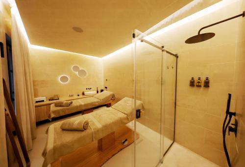 a bathroom with two beds and a shower at Casa Nostra Luxury Suites & Spa in Palermo