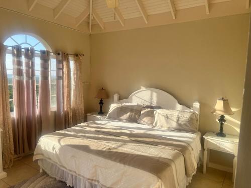 a bedroom with a white bed and a window at Retreat Guest House in Falmouth