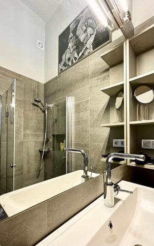 a bathroom with a sink and a shower at 4m high apartment in heart of Warsaw! in Warsaw