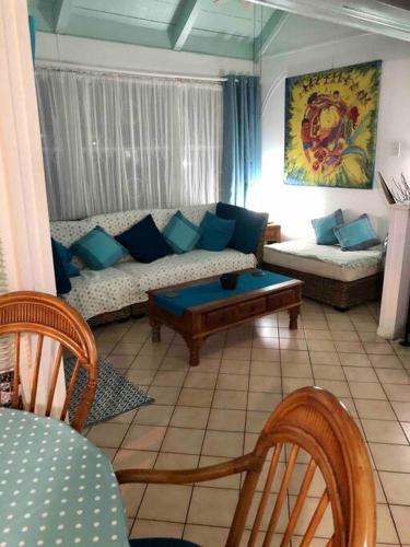a living room with a couch and a table at 12 Sealofts On The Beach - Frigate Bay in Frigate Bay