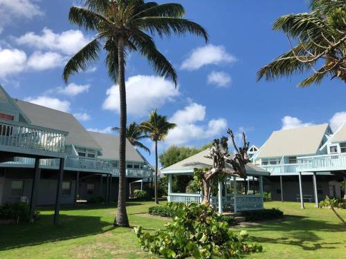 a group of houses with palm trees in the yard at 12 Sealofts On The Beach - Frigate Bay in Frigate Bay