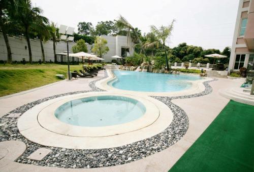 a swimming pool with rocks around it at a resort at Le Beau Max Resort in Fanlu