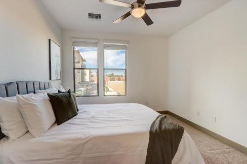 a bedroom with a large bed with a ceiling fan at Modern CozySuites on the Town Lake waterfront 17 in Tempe