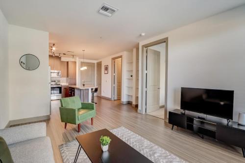 a living room with a flat screen tv and a couch at Modern CozySuites on the Town Lake waterfront 17 in Tempe