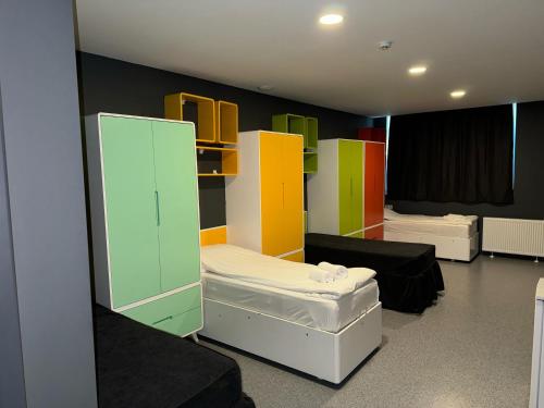 a room with several beds and colorful cabinets at Aderans Hotel in Istanbul