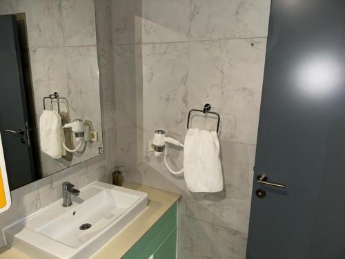 a bathroom with a sink and a mirror at Aderans Hotel in Istanbul