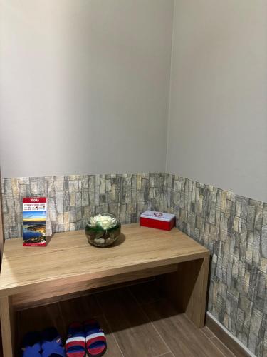 a wooden shelf with a bowl on top of it at Ralph Apartments in Vlorë