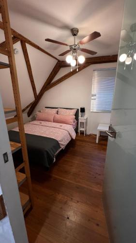 a bedroom with a bed and a ceiling fan at Ferienwohnung am Schlössle in Ochsenfurt