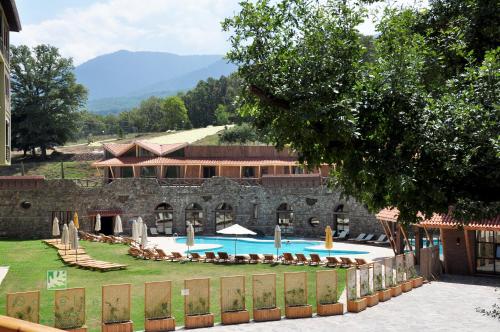 a resort with a swimming pool and a building at Gazelle Resort & Spa in Bolu