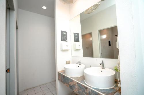 a bathroom with two sinks and a mirror at Mad Monkey Chiang Mai in Chiang Mai