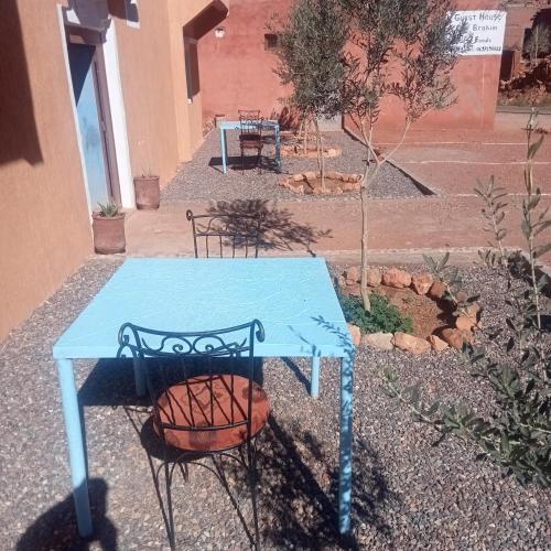 a blue table and chairs sitting next to a building at Dar Brahim Resto Beds in Ouarzazate