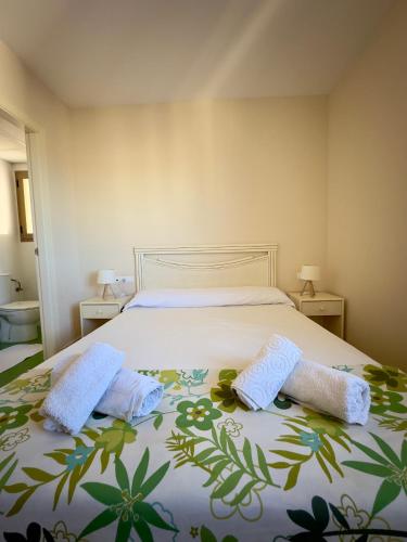 a bedroom with a bed with two towels on it at Esmeralda Suites Calpe in Calpe