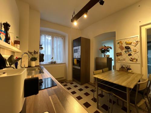 a kitchen with a wooden table and a dining room at Ferien am Schlössle in Ochsenfurt