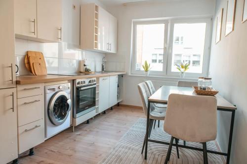 a kitchen with a table and a dining room at bright & grey - Netflix - City - Wifi - 4 Person in Essen