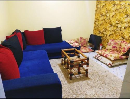 a living room with blue couches and chairs at Gill's Crib in Maseno