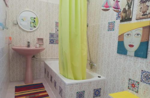 a bathroom with a yellow shower curtain and a sink at Zagara di Sicilia in Marsala