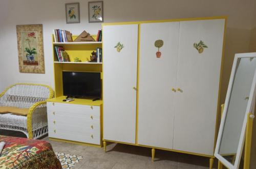 a bedroom with a desk and a cabinet and a tv at Zagara di Sicilia in Marsala