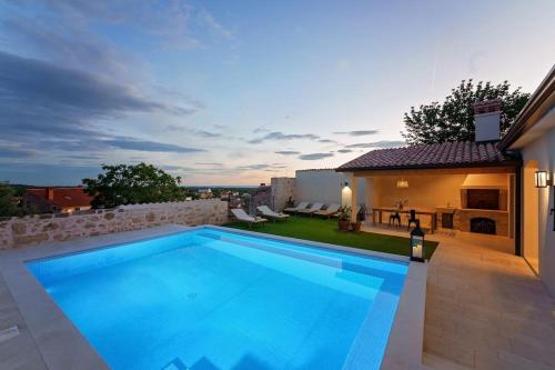 a swimming pool in the backyard of a house at Villa Santina by Briskva in Višnjan