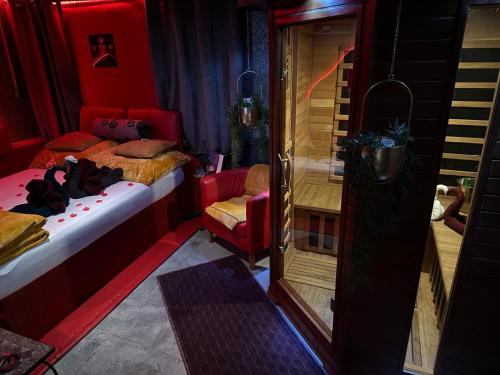 a bedroom with a bed and a chair and a mirror at Apartmán Mair Pardubice in Pardubice