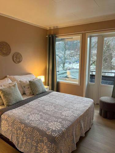 a bedroom with a large bed and a window at Fagre Stryn Feriehus in Stryn