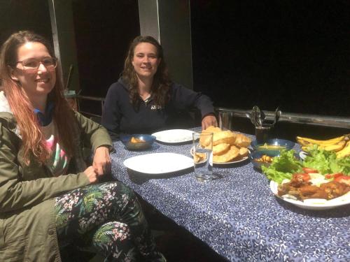 two women sitting at a table with plates of food at Hamadhi guest in Haldummulla