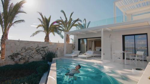 a swimming pool in the backyard of a house at The Island Concept Luxury Boutique Hotel Heated Pool in Agios Nikolaos