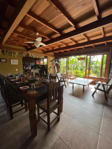 a dining room with a large table and chairs at Pousada Alma da Gamboa in Gamboa