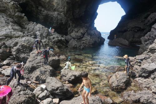 a group of people standing in the water in a cave at Morizuya in Toyooka