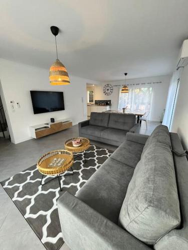 a living room with a couch and a tv at Villa Victoria #8 persons #3 Bedrooms #Terrace # garage Beach - Calm and Clim in Roquebrune-Cap-Martin