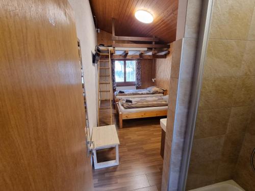 a small room with a bunk bed and a door at Le Catogne in Orsières