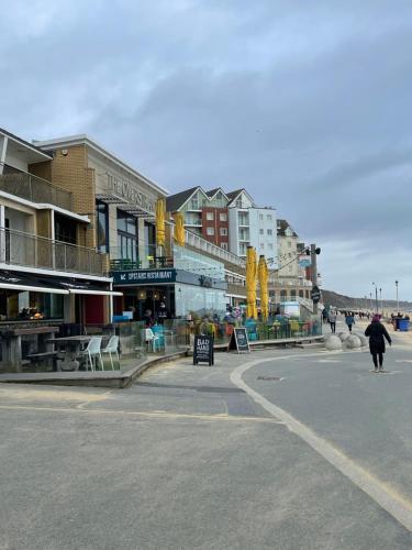a person walking down a street in a city at Burlington Mansions in Bournemouth