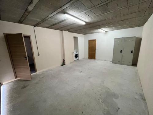 an empty room with a garage with two doors and a washer at Villa Victoria #8 persons #3 Bedrooms #Terrace # garage Beach - Calm and Clim in Roquebrune-Cap-Martin