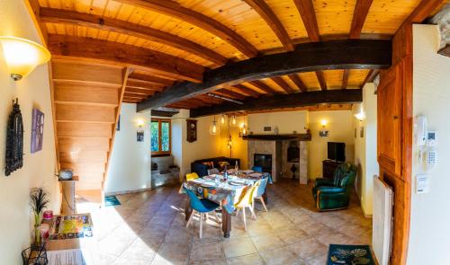 a large living room with a table and chairs at Gîte de benque in Benqué