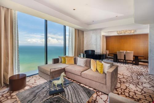 a living room with a couch and a table at Mövenpick Hotel Colombo in Colombo