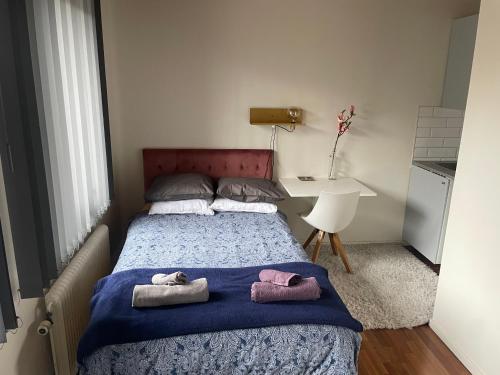 a bedroom with a bed with two towels on it at Studio 3 in Landskrona