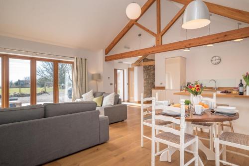 a living room with a couch and a table at Hafod-Llecheiddior in Brynkir